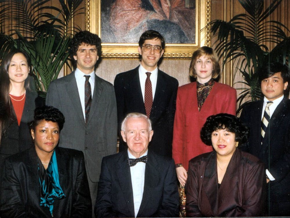 Eisgruber with his wife Lori, Supreme Court Justice John Paul Stevens, and Stevens' clerks in the spring of 1990.