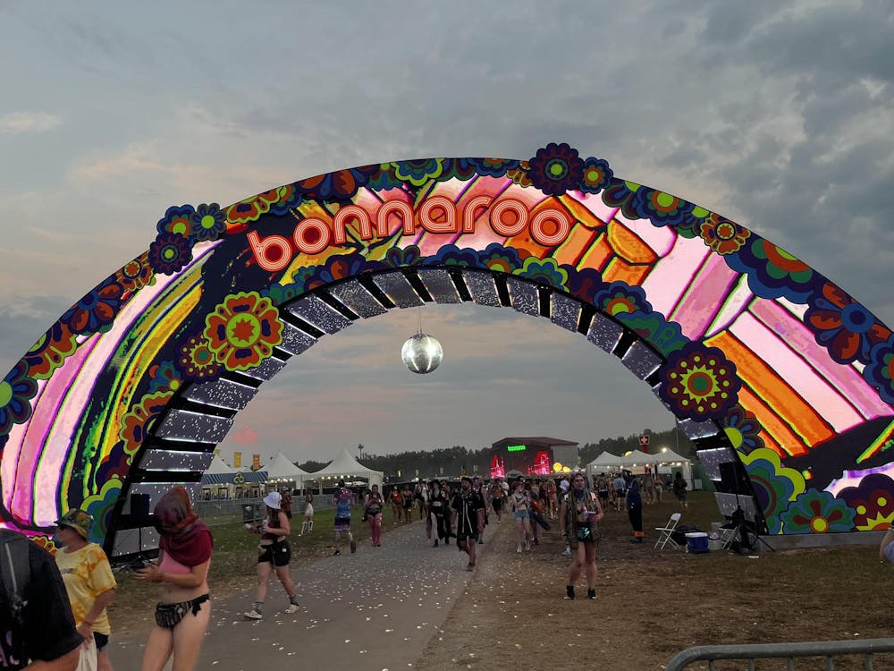 The colorful, arched entrance of the Bonnaroo music festival. The balloons spell out “Bonnaroo.”