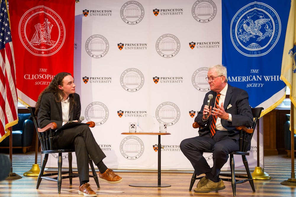 Two people speak against a white backdrop with the Princeton logo and the Whig-Clio logo.