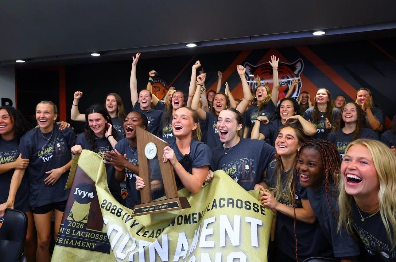 While holding the championship banner and trophy, members of the Princeton women's lacrosse team celebrate after hearing their name called on the NCAA selection show.