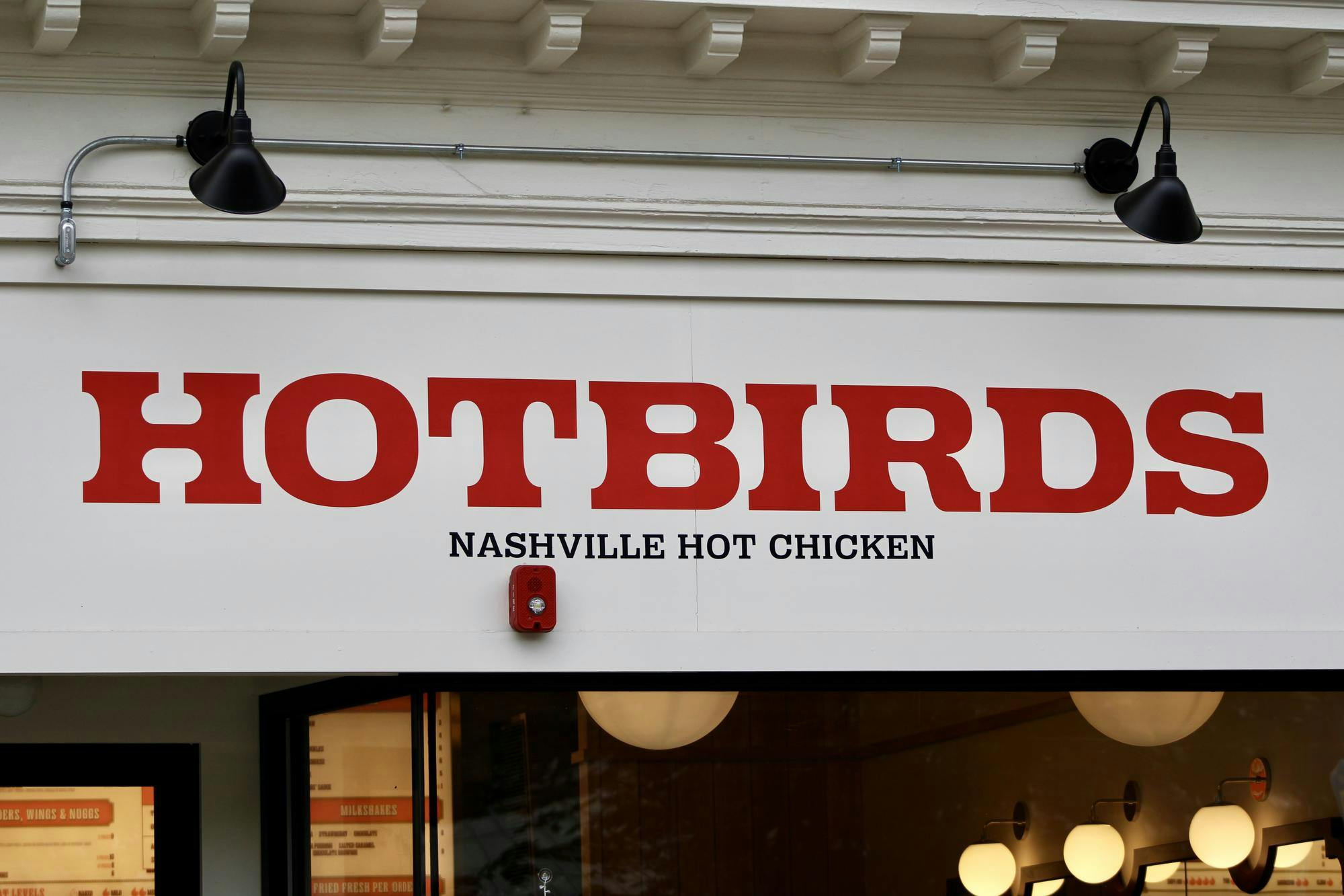 Red Hotbirds sign on a white background.