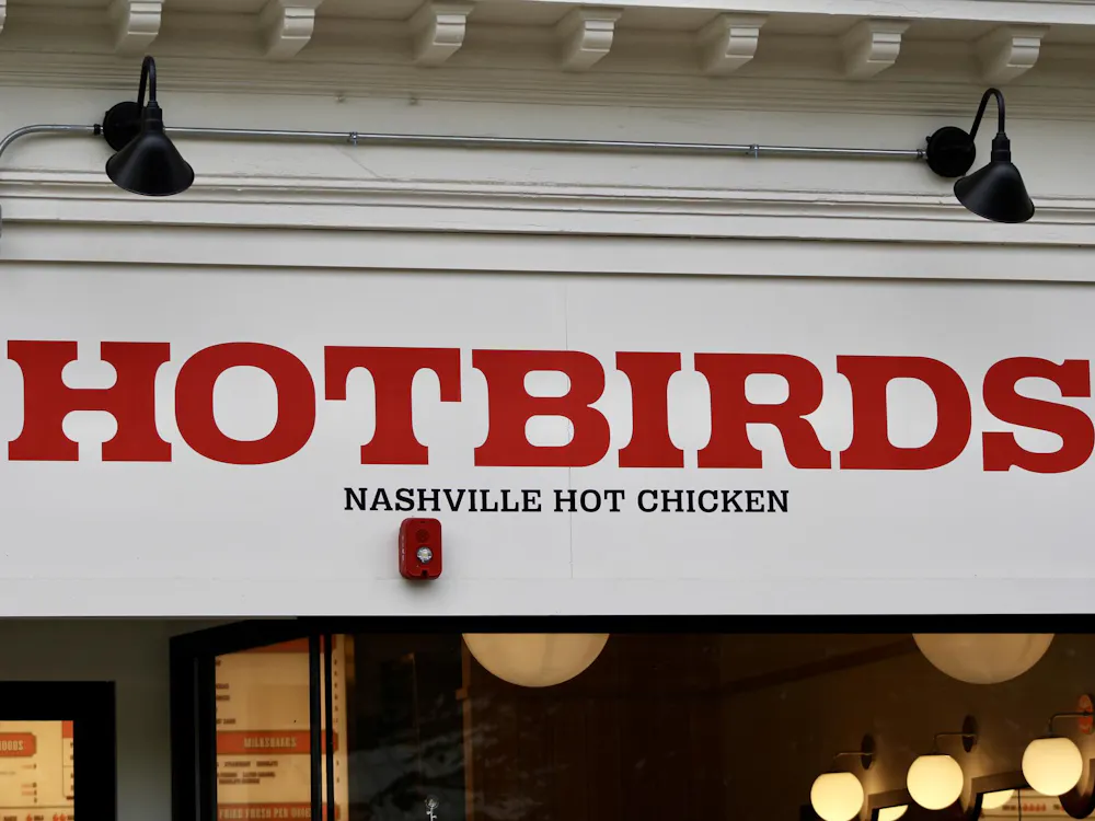 Red Hotbirds sign on a white background.