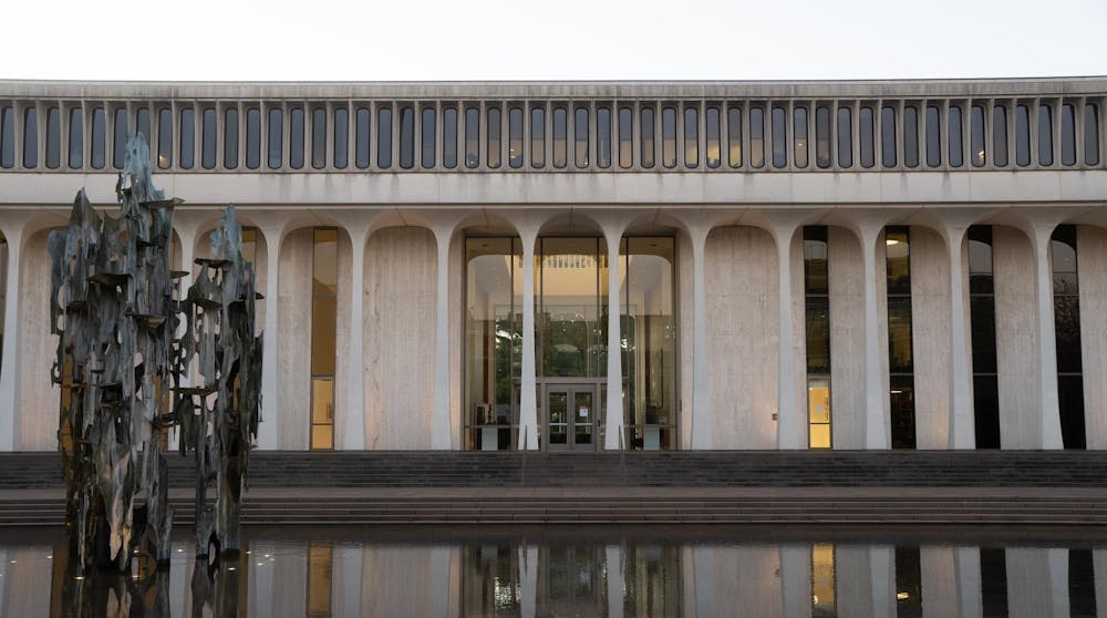 A fountain in front of a white building with columns.