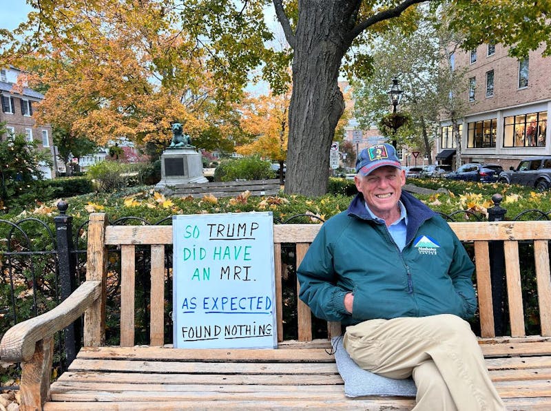 Activism in Palmer Square: A man, a bench, and a sign