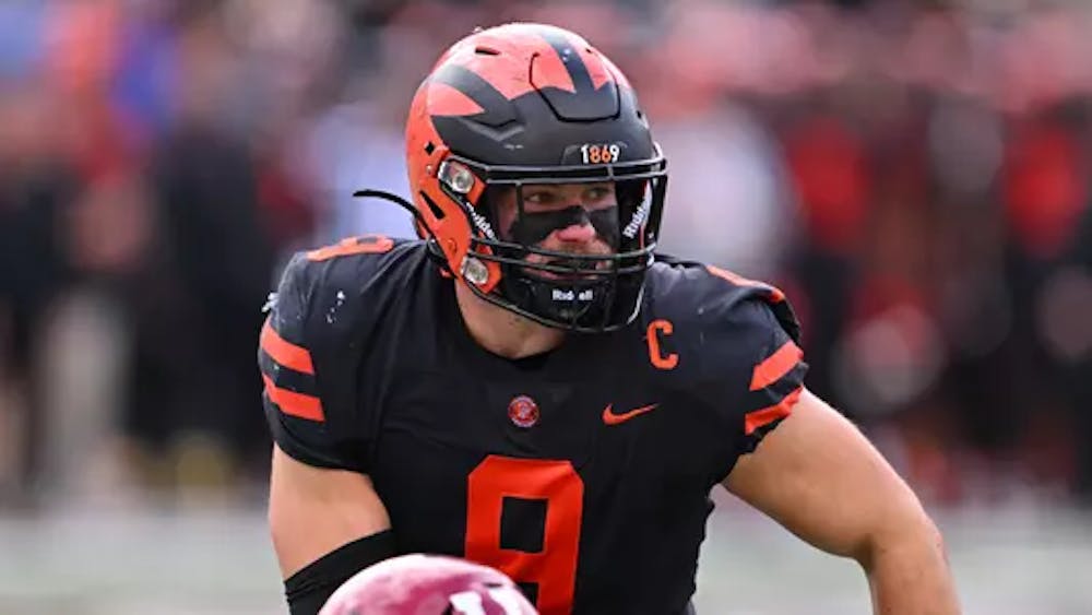 Man in black and orange football jersey and helmet