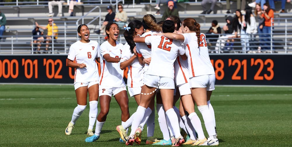 A women’s soccer celebrates after a goal.