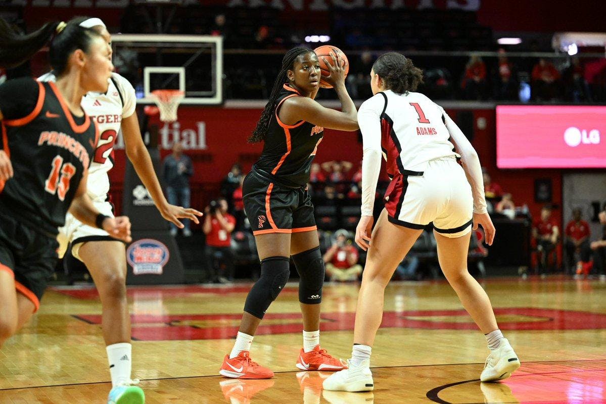 Tiger women’s basketball player protects ball against a Rutgers defender