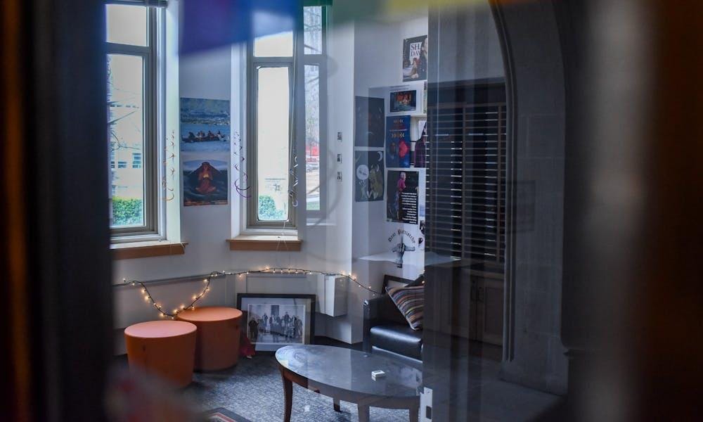 An office space with lights, photos, and posters on a wall. 