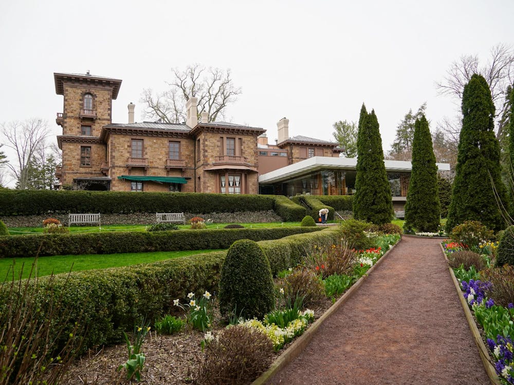 A mansion can be seen behind the garden. 