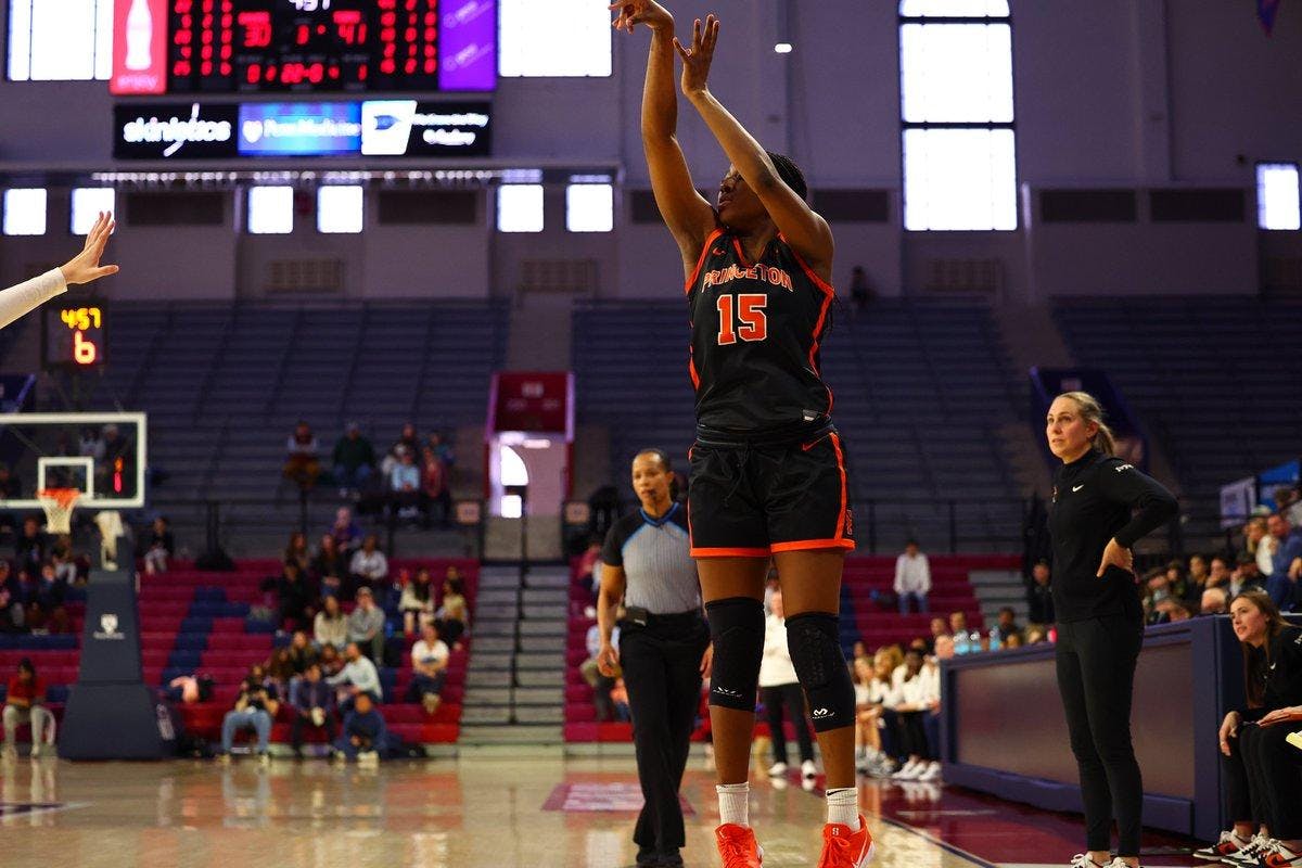 Woman shooting a basketball.