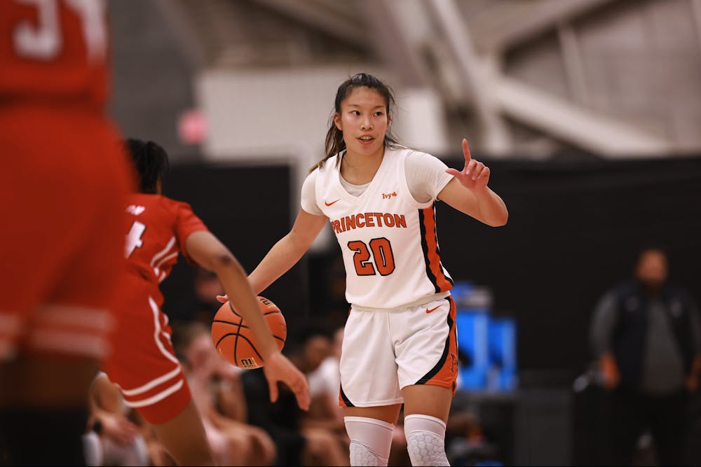 Senior guard Kaitlyn Chen dribbles the ball, pointing her finger upwards and directing the Tigers offense.