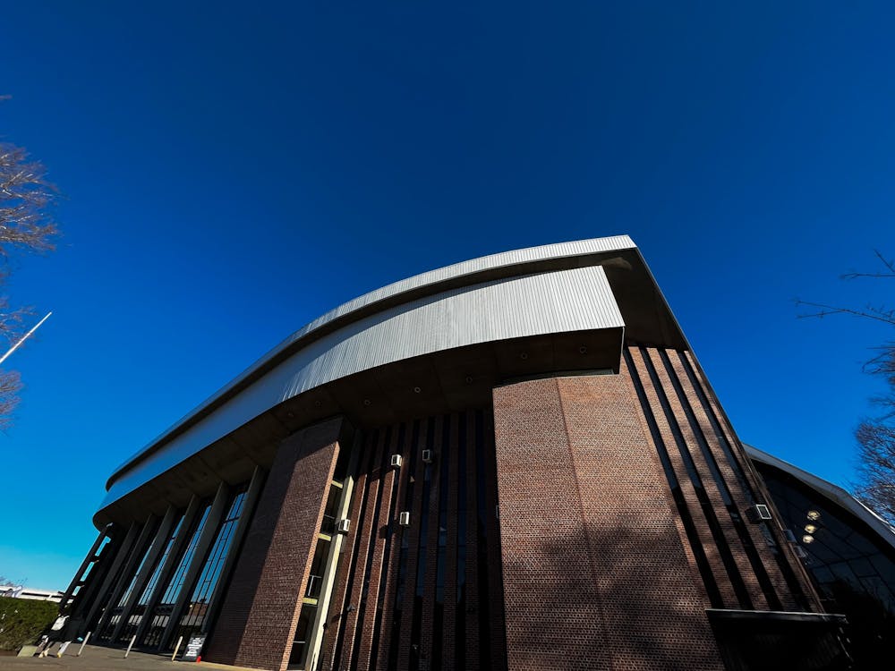 The photo features an ominous-looking brick building with a steel top.