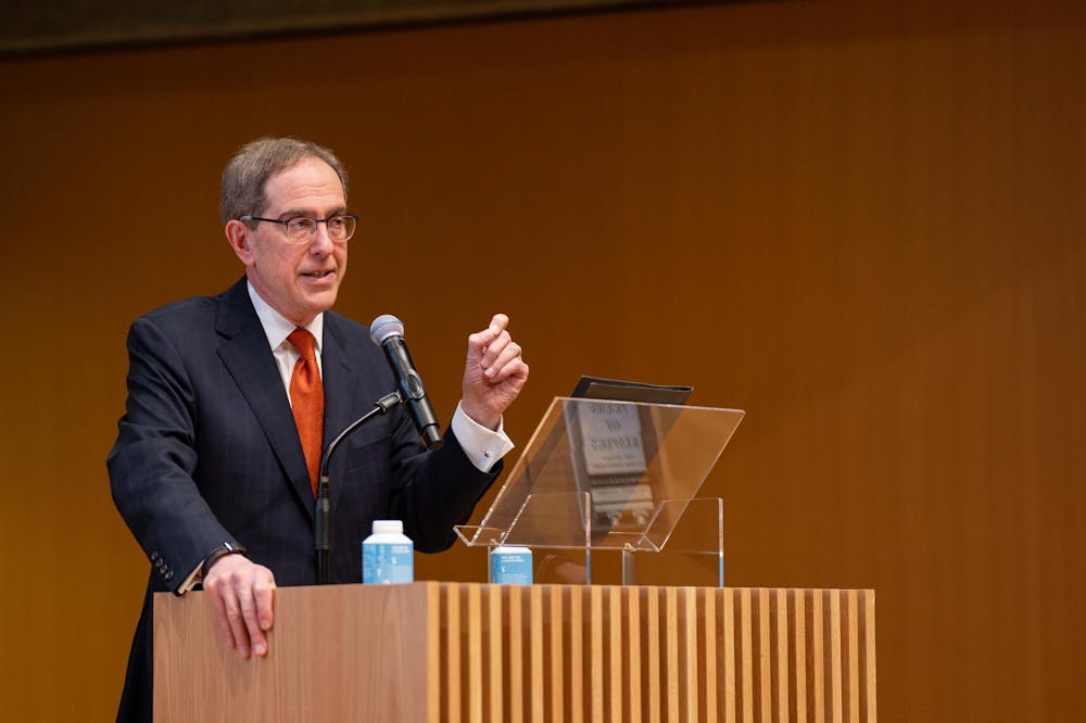 University President Christopher Eisgruber speaks at a podium in the Princeton University Art Museum's Grand Hall. 