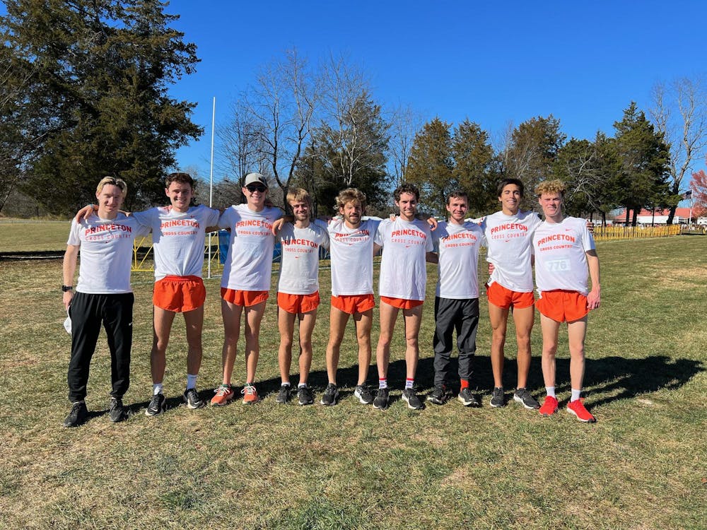 nine boys in white princeton cross country shirts stand in line with arms around each other