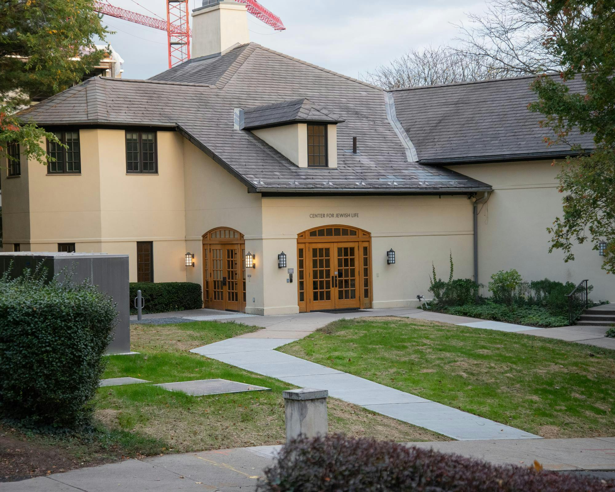 A pale yellow building is illuminated by gentle sunlight. 