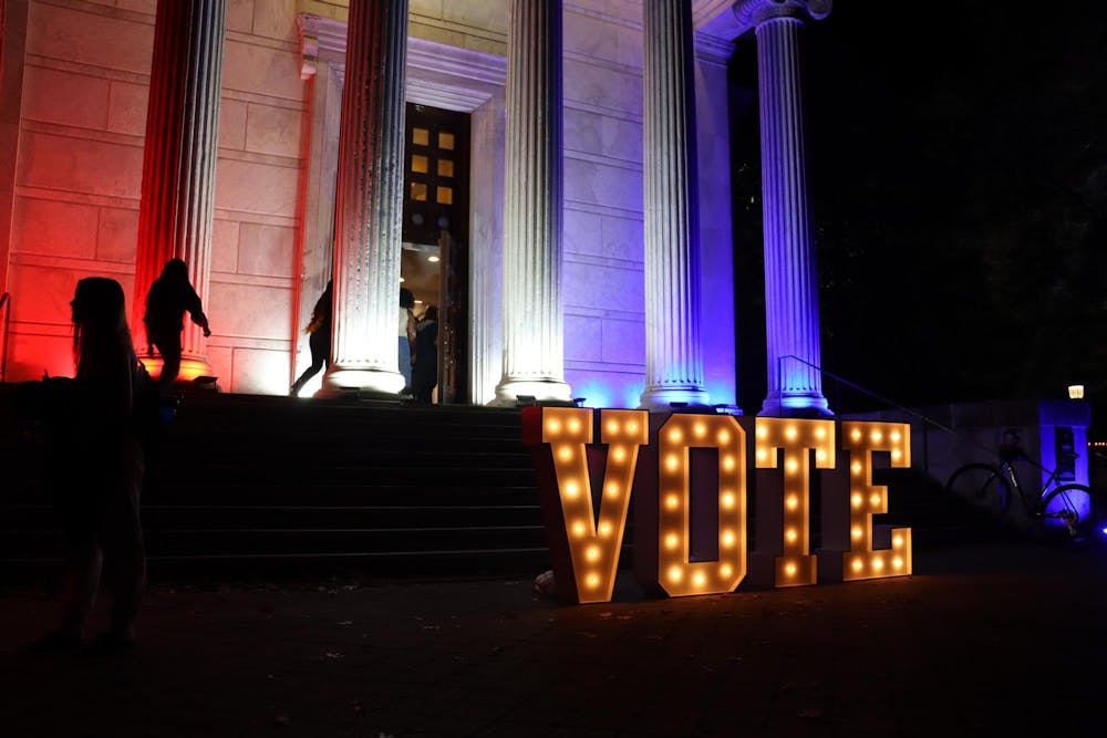 Large light-up letters saying "Vote" outside the steps of Whig.