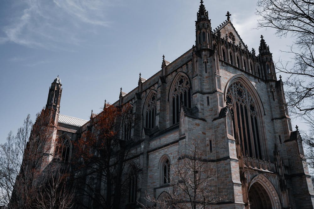 A chapel with many windows on a partly cloudy day.