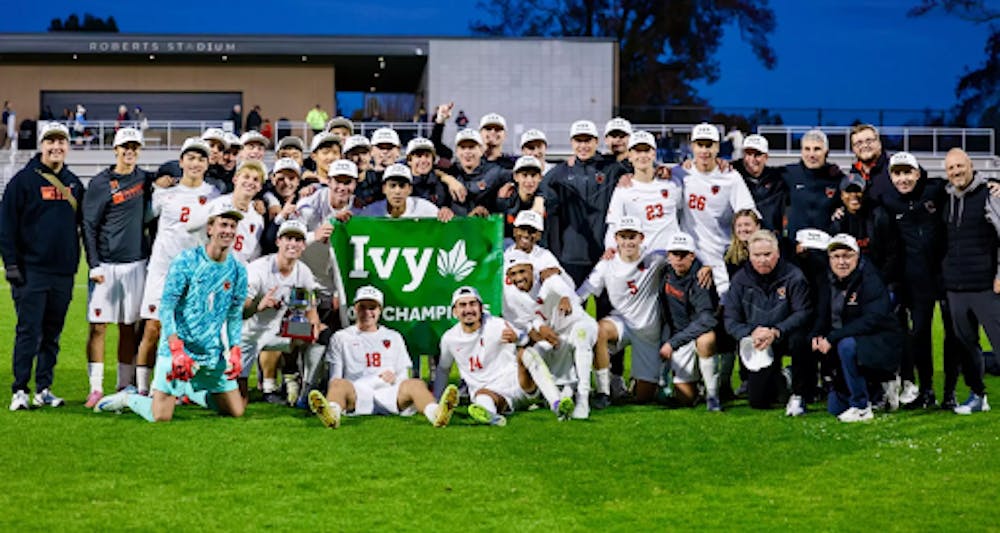 A group of men in white jerseys holding up the Ivy Champions sign after winning a the regular season.