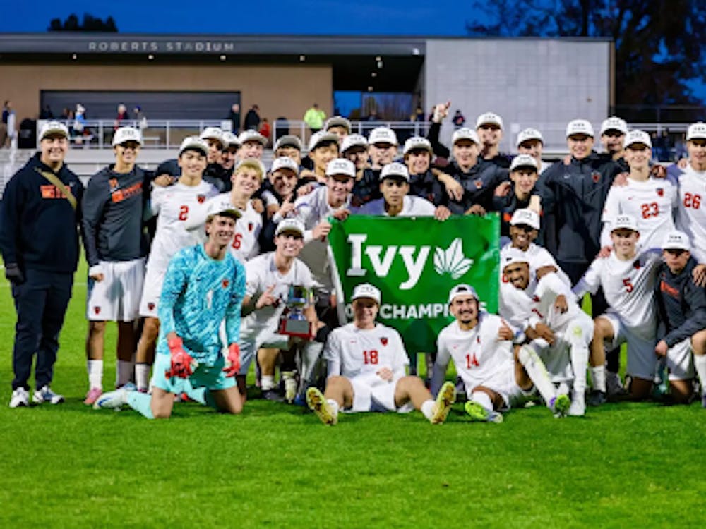 A group of men in white jerseys holding up the Ivy Champions sign after winning a the regular season.