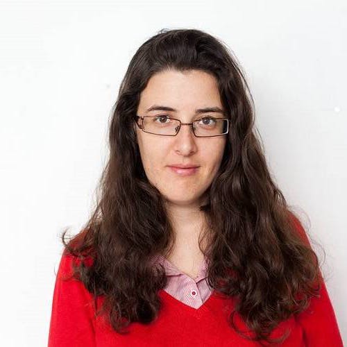 Woman with brown hair with glasses.
