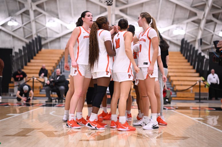 Princeton women’s basketball team in a huddle.