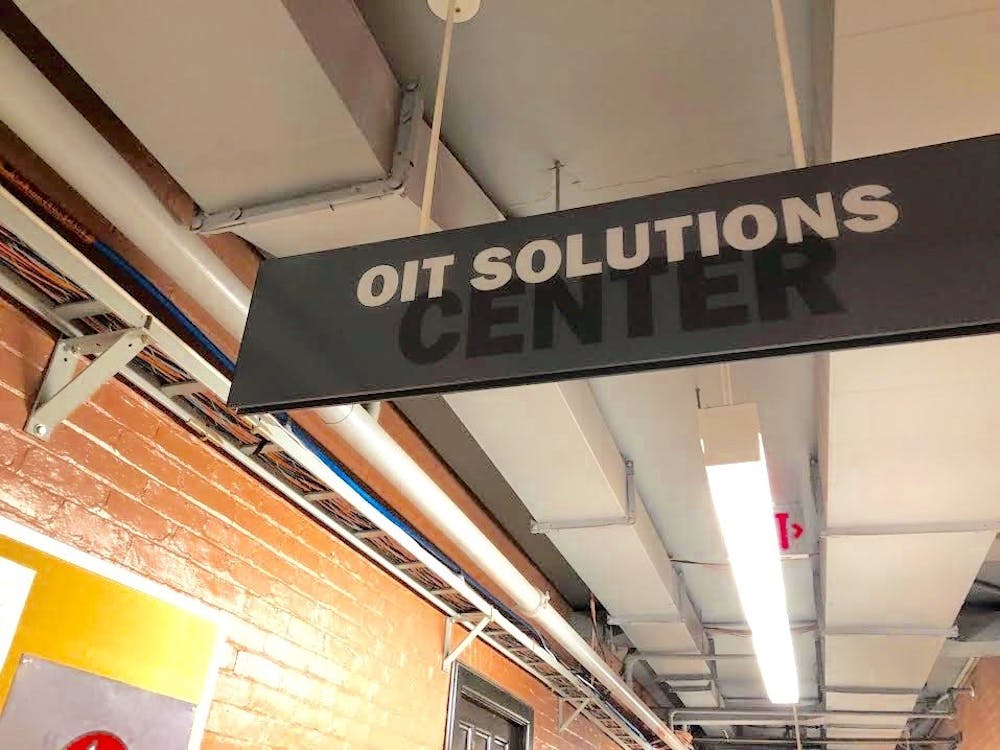 A sign for the OIT Solutions Center hangs in the 100 level of Princeton's Frist Center.