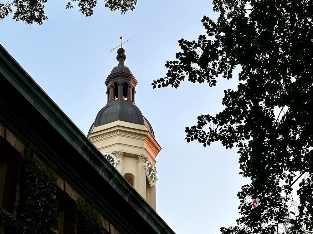 The tower of Nassau Hall is shown on the left and trees are shown on the right.