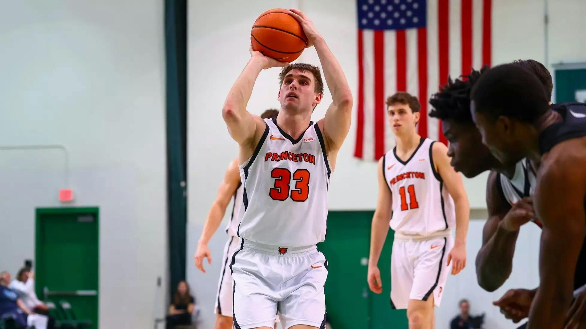 Princeton player in a white jersey shoots a free throw.