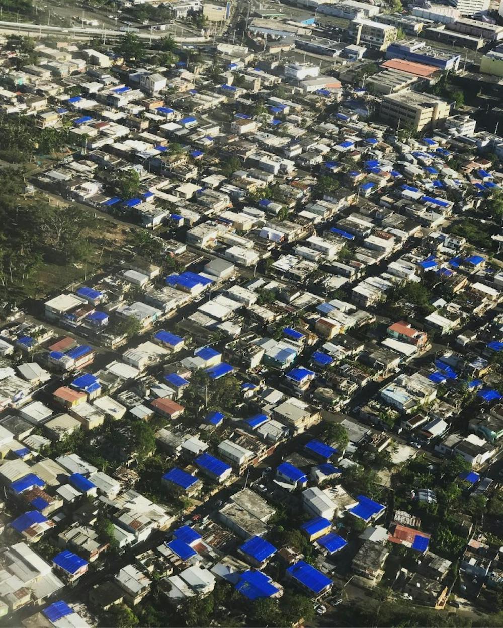 Thousands are still living in houses with provisional blue plastic tarps as roofs.