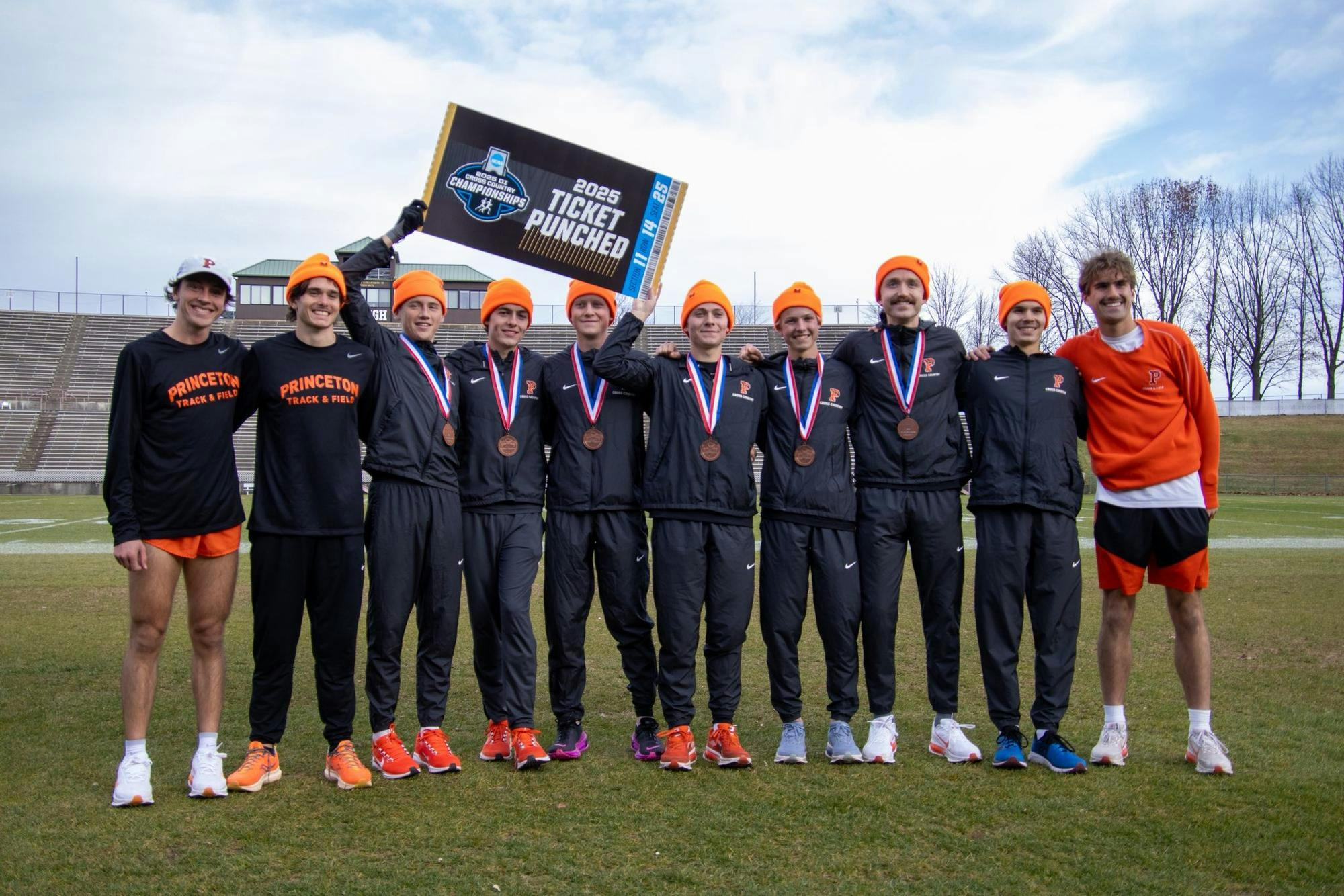 Princeton mens cross country runners hold a sign that reads 2025 Ticket Punched.