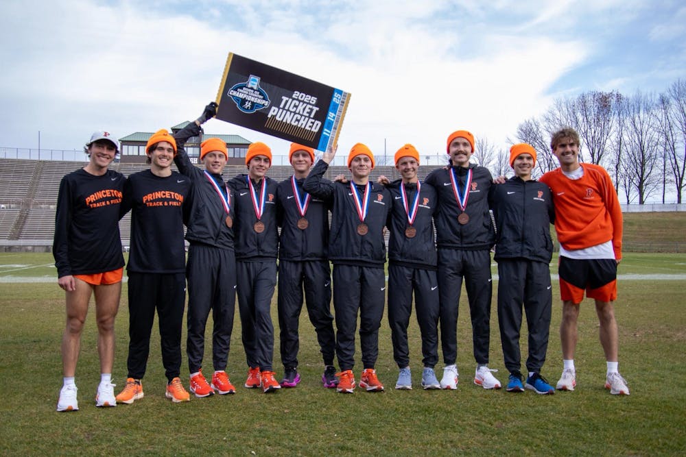 Princeton mens cross country runners hold a sign that reads 2025 Ticket Punched.