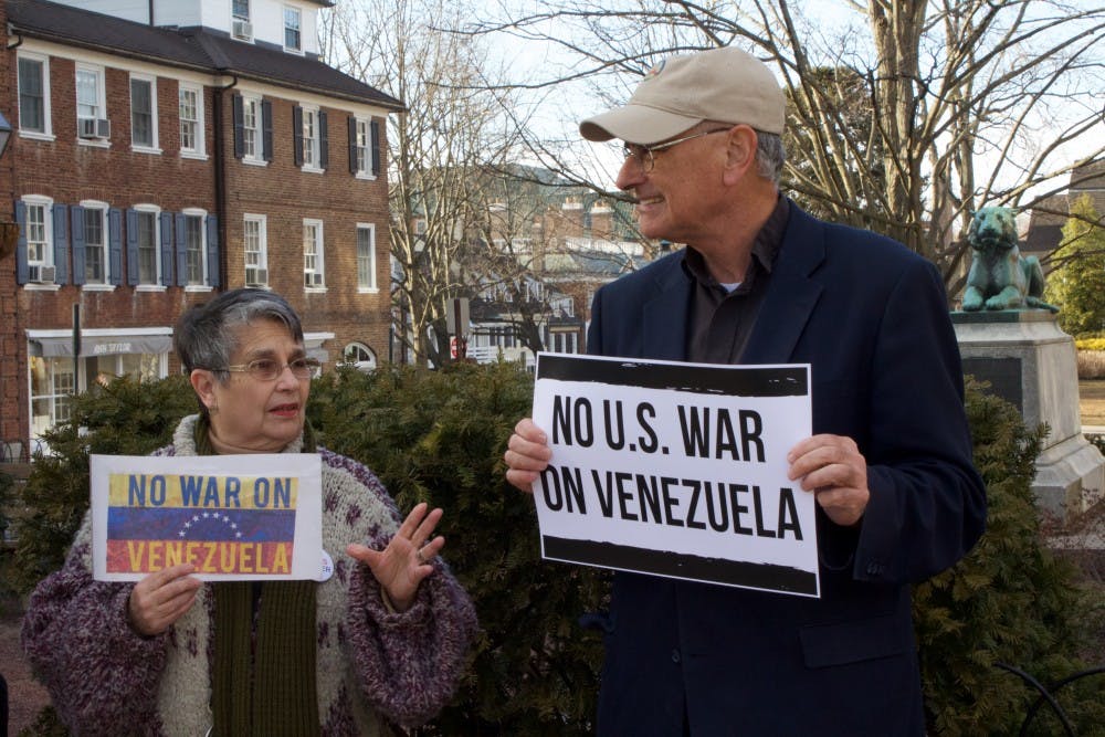 <p>Retiree Alma Concepcion and Reverend Bob Moore, Executive Director of the Coalition for Peace Action, hold up anti-war signs. Photo taken by Claire Thornton / The Daily Princetonian</p>