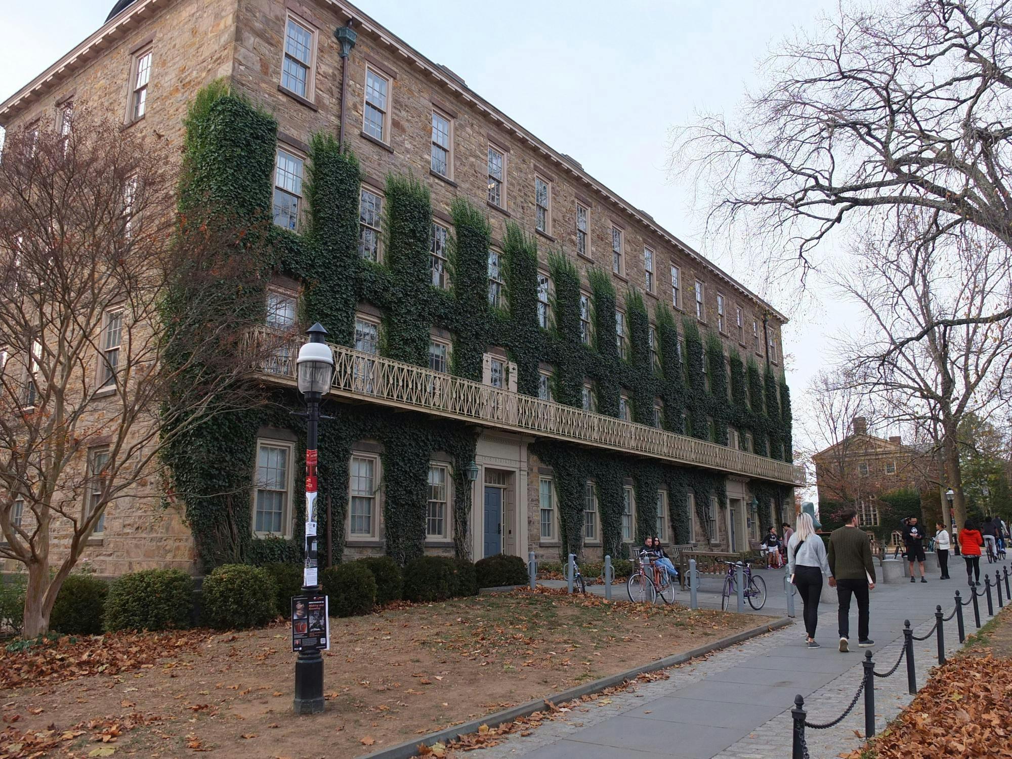 A brown brick building with ivy.