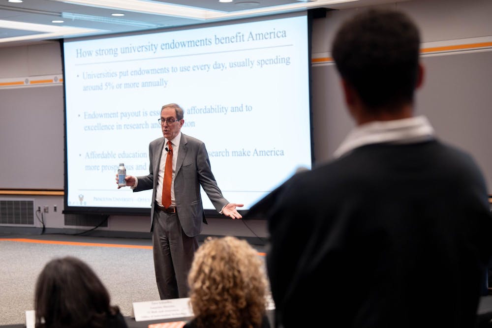 A man shrugs in front of a screen reading "how strong university endowments benefit America"