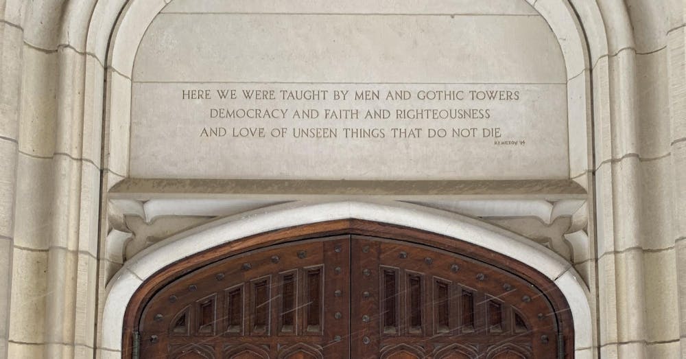 Above the dark wooden doorway to the McCosh 50 classroom is a quote from H.E. Mierow '14, reading "Here we were taught by men and gothic towers / democracy and faith and righteousness / and love of unseen things that do not die.