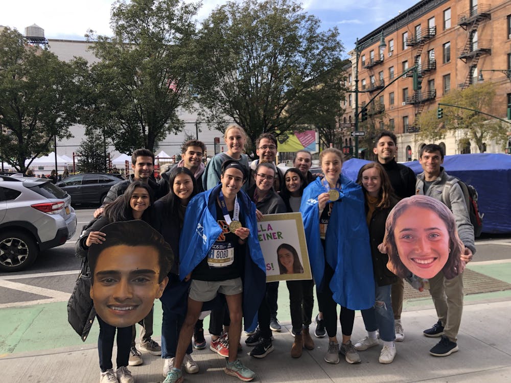 <h5>Seniors Sebastian Quiroga and Ella Feiner pose with friends after completing the 2021 New York City Marathon.</h5>
<h6>Courtesy of Feiner</h6>