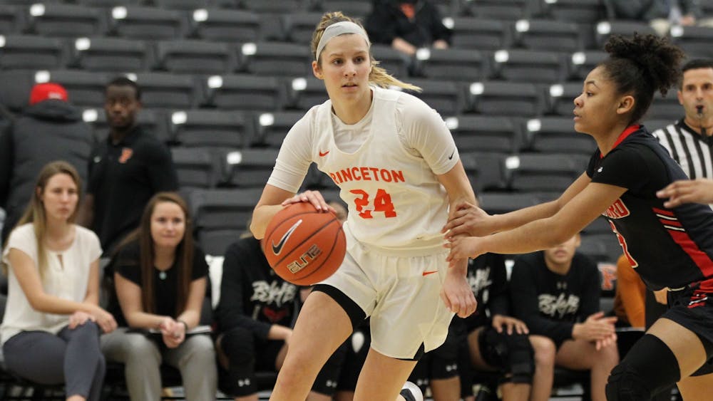<h5>Julia Cunningham '23 dribbling the ball in a home game against Harvard last winter.</h5>
<h6>Beverly Schaefer / Princeton University Athletics</h6>