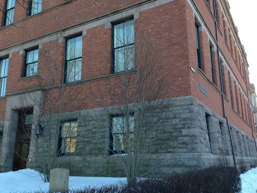 Photo of the corner of Aaron Burr Hall in the winter during the day. 