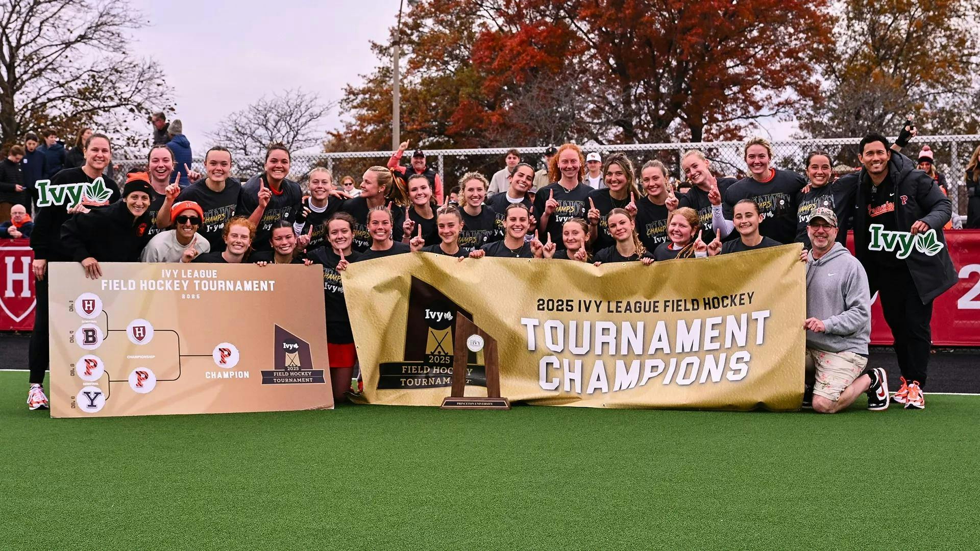 People pose in front of signs.