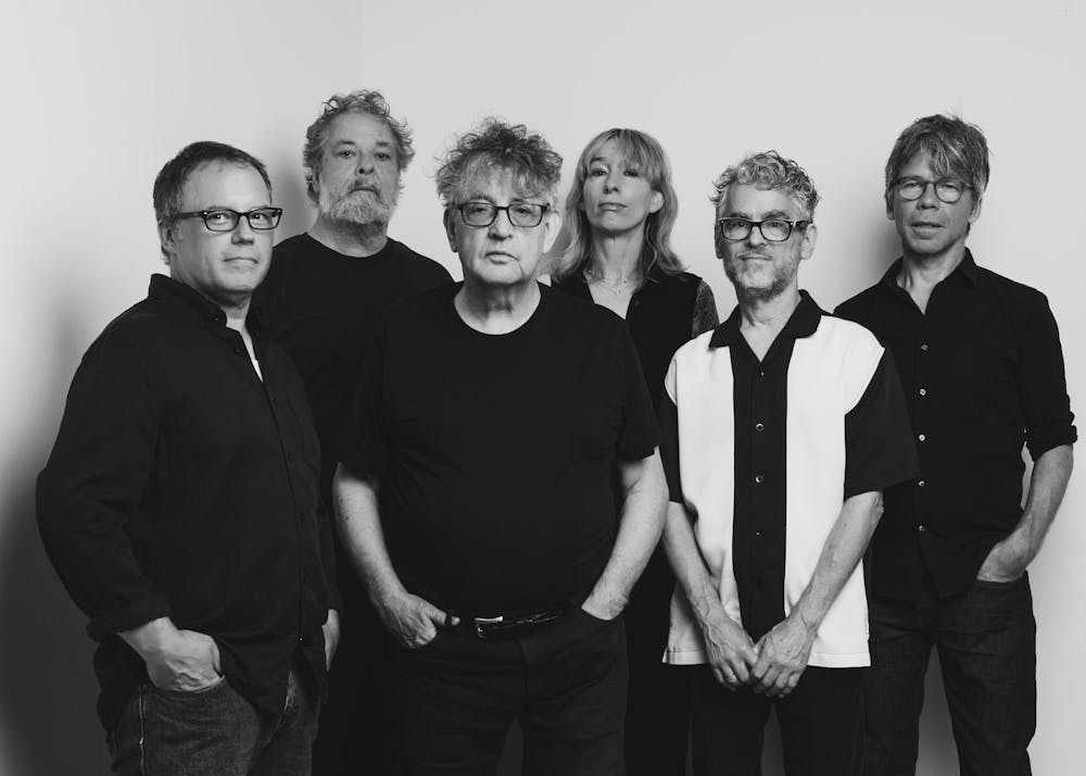 A black and white photo of a group of six people. 