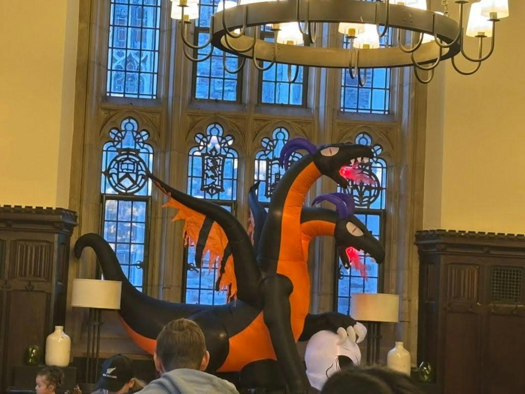 A black and orange blow up dragon with two heads.