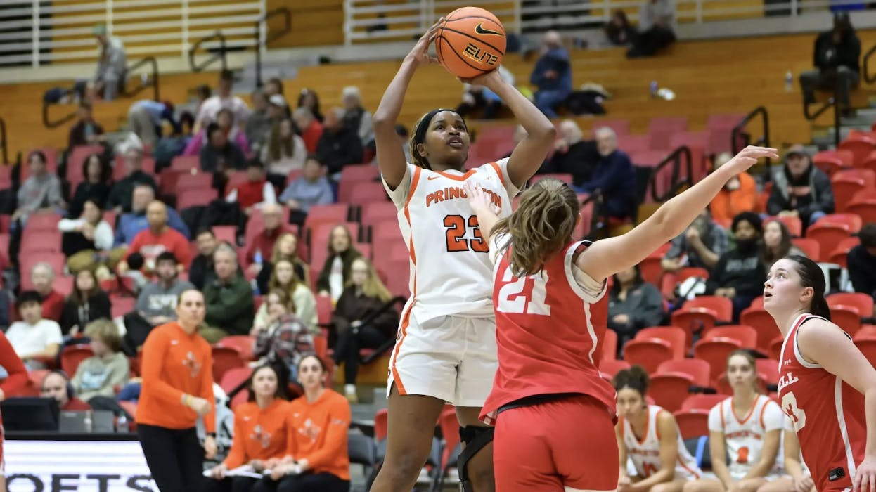 Two basketball players competing for the victory at Newman Arena.