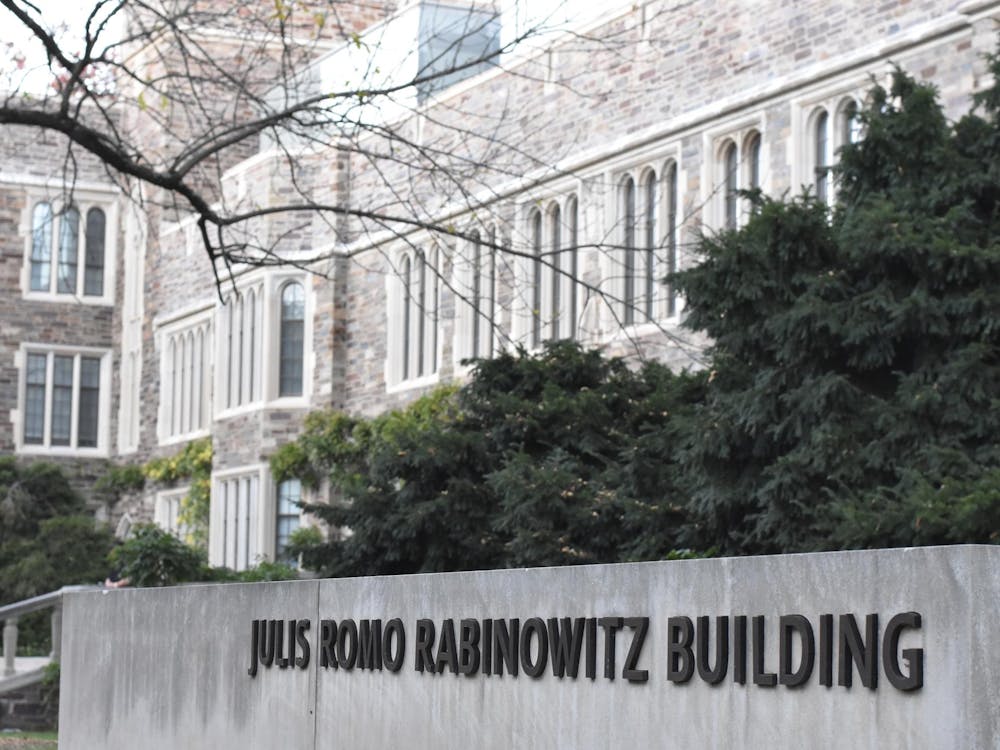 A sign reading Julis Romo Rabinowitz Building in the foreground of a gothic building.