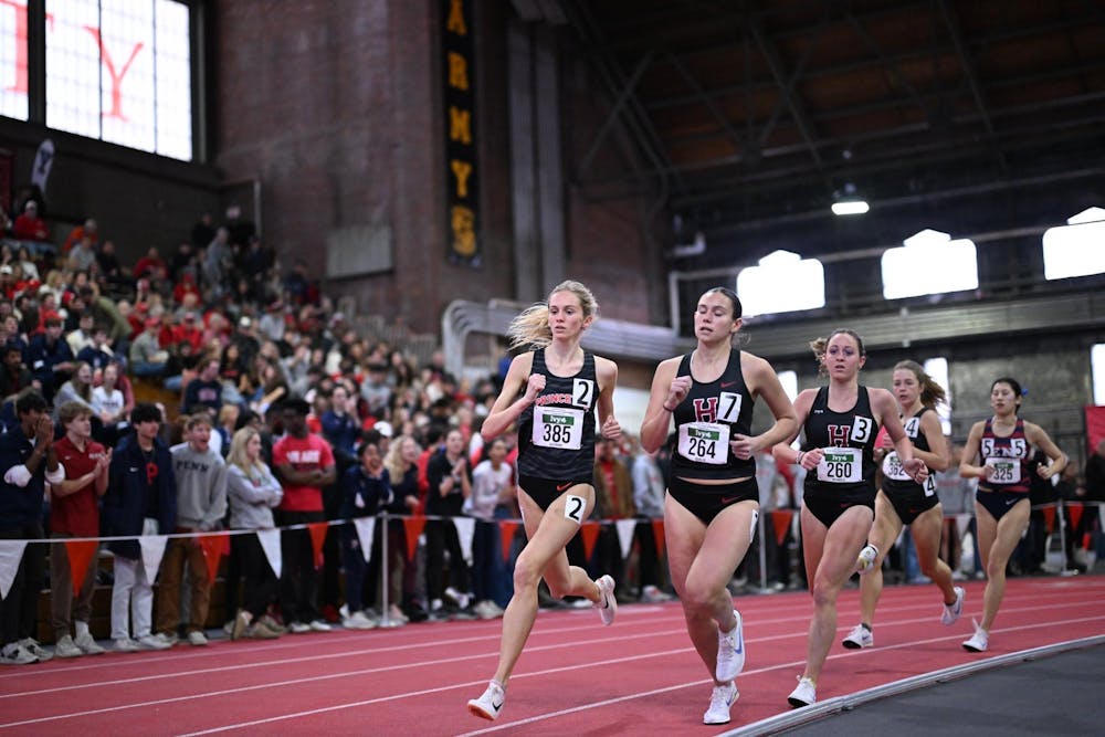 Women running around a track.