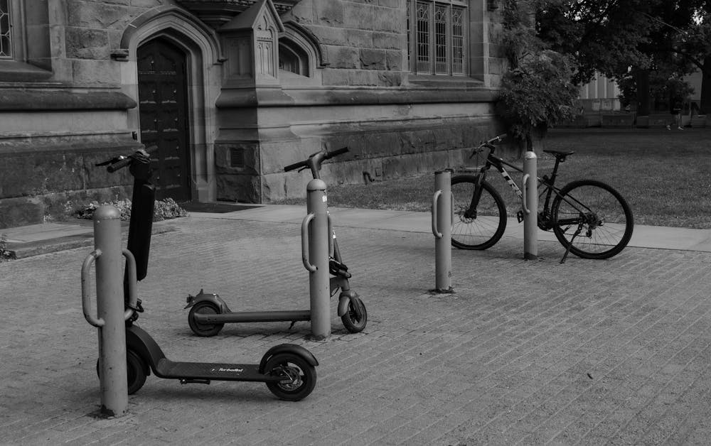 Photo of scooters parked outside East Pyne Hall in black and white.