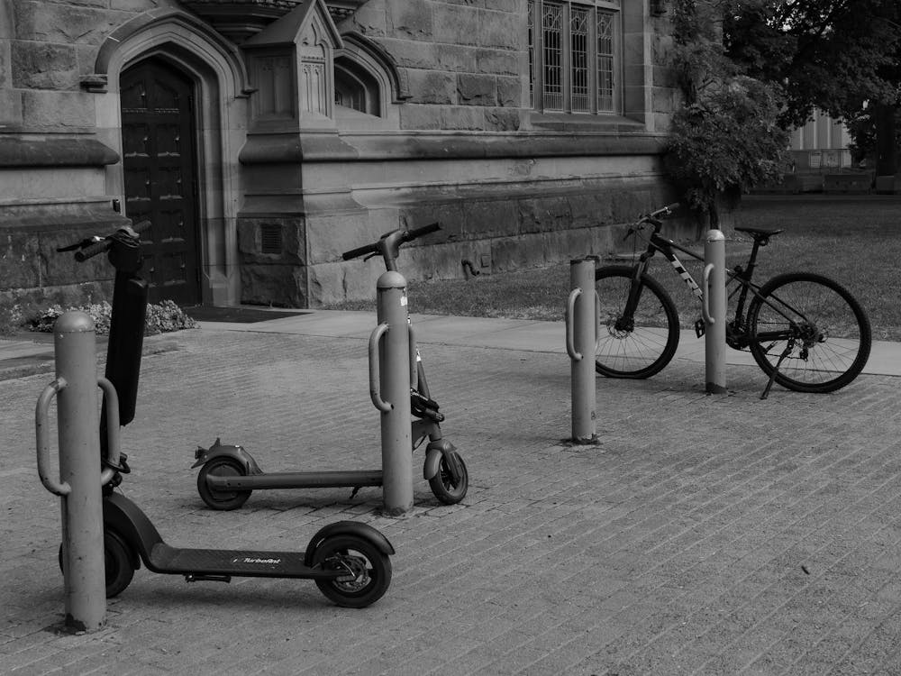 Photo of scooters parked outside East Pyne Hall in black and white.