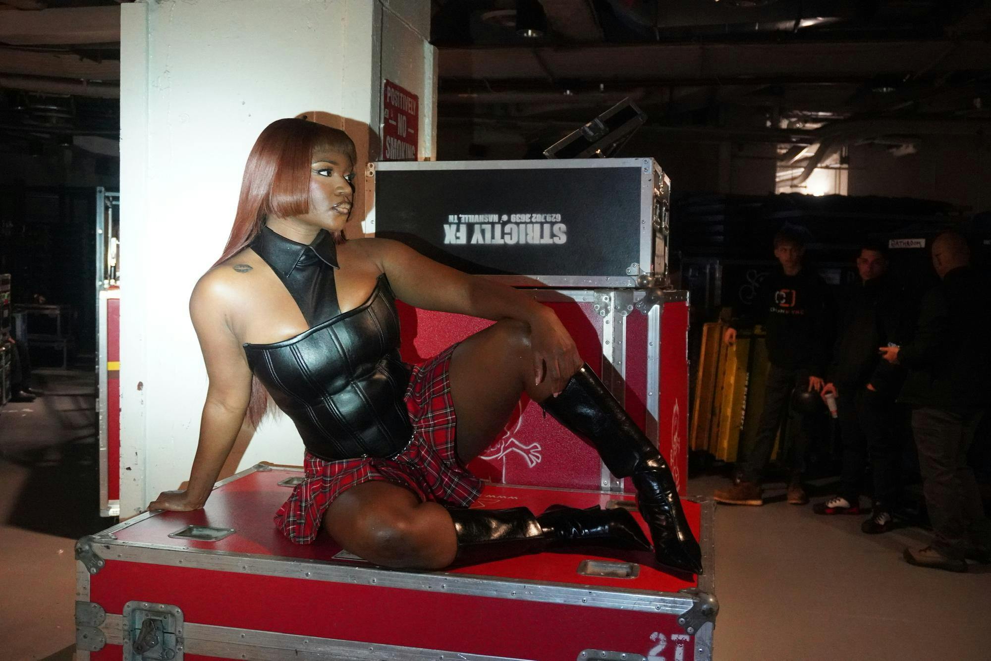 Amaarae poses in front of performance equipment.