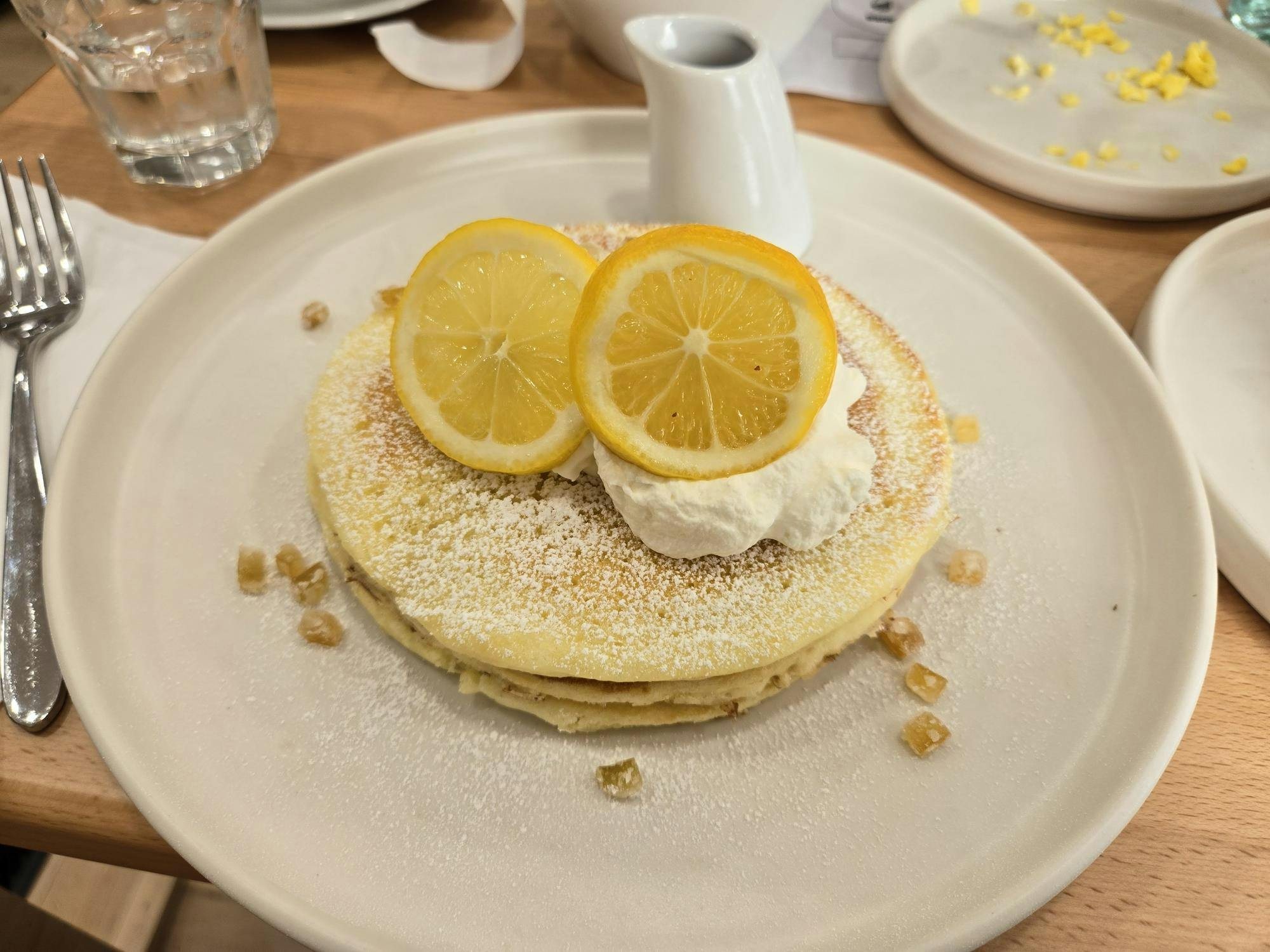 pancakes with cut lemons on top.