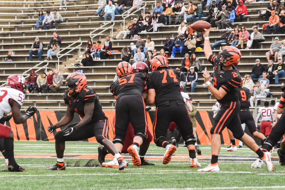 <h5>Senior quarterback Cole Smith drops back to pass in Princeton's matchup against Harvard.</h5>
<h6>Mark Dodici / The Daily Princetonian</h6>