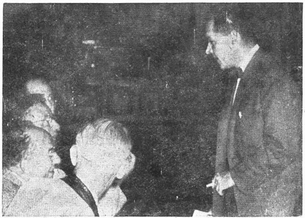Black and white photograph of President Goheen smoking in the faculty room of Nassau Hall after the faculty meeting that enacted the smoking ban. 